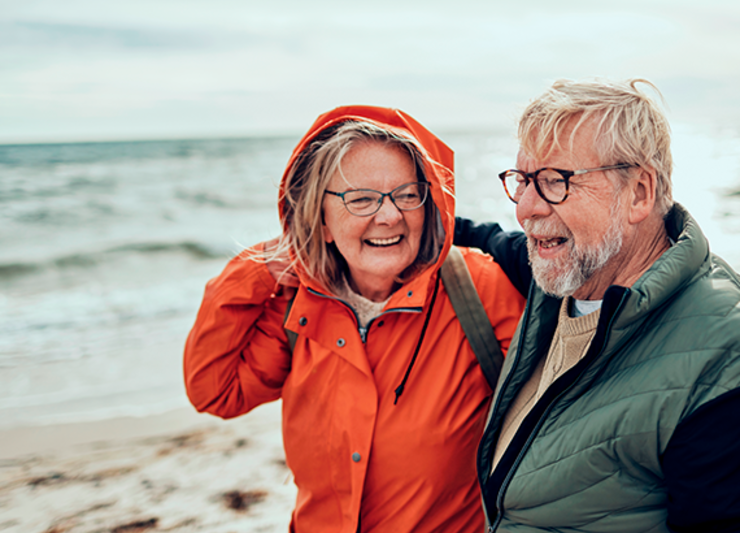 Patient and their spouse walking on the beach outside of dialysis therapy